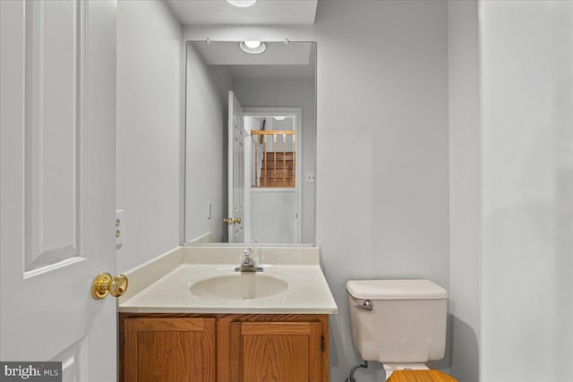 bathroom with toilet and vanity