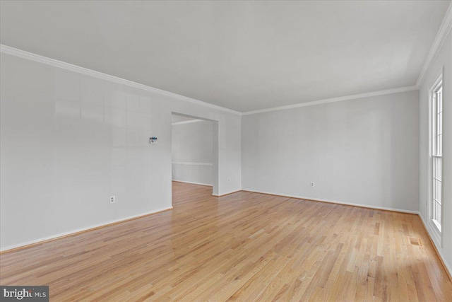 unfurnished room with ornamental molding and light wood-type flooring