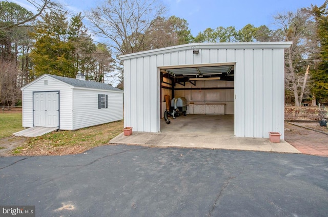 detached garage with aphalt driveway