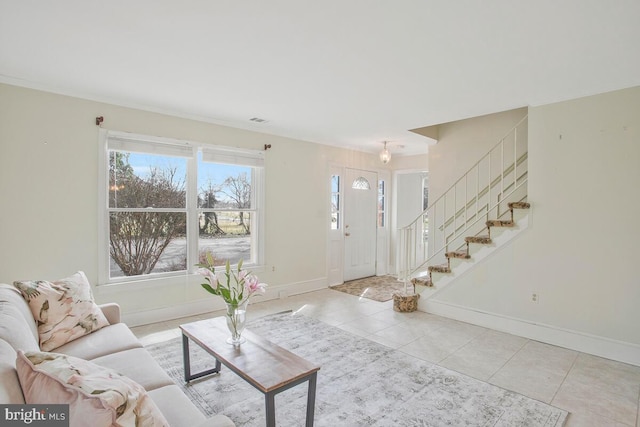 tiled living area featuring stairway, visible vents, and baseboards