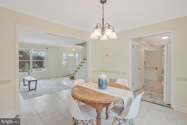 dining area featuring ornamental molding, light tile patterned flooring, a chandelier, baseboards, and stairs