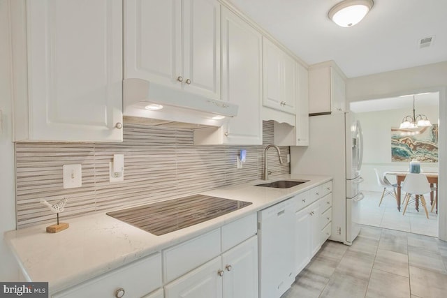 kitchen featuring under cabinet range hood, white appliances, a sink, visible vents, and white cabinets