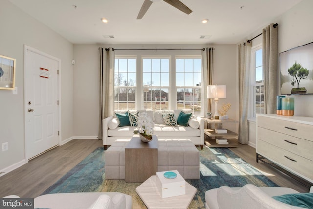 living room with recessed lighting, dark wood finished floors, visible vents, and baseboards