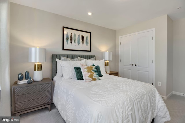 bedroom with carpet floors, baseboards, a closet, and recessed lighting