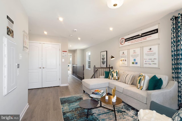 living room with recessed lighting, baseboards, and wood finished floors