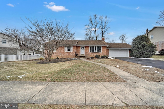 ranch-style house with driveway, a garage, a chimney, fence, and brick siding