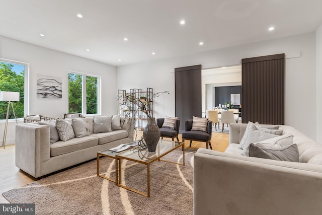 living room with light wood-style floors and recessed lighting