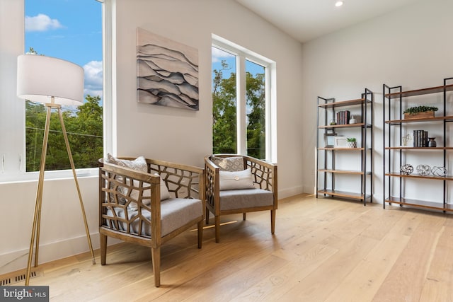 sitting room featuring light wood-style floors, recessed lighting, and baseboards