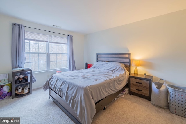 carpeted bedroom featuring visible vents