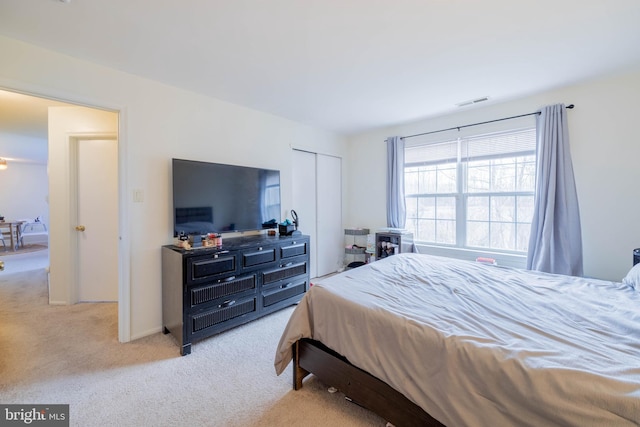 bedroom featuring a closet, visible vents, and carpet flooring