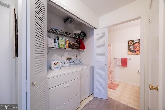 laundry area featuring laundry area, baseboards, light floors, and washer and dryer