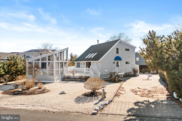 back of property featuring a sunroom