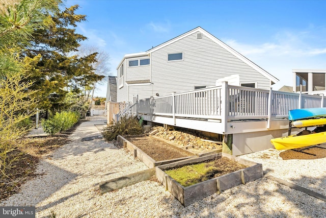 14 Buckingham Ave, Harvey Cedars, NJ 08008 - rear view of house featuring a garden and a wooden deck