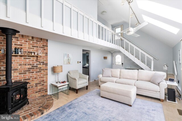 14 Buckingham Ave, Harvey Cedars, NJ 08008 - living area with a wood stove, a skylight, stairs, and high vaulted ceiling