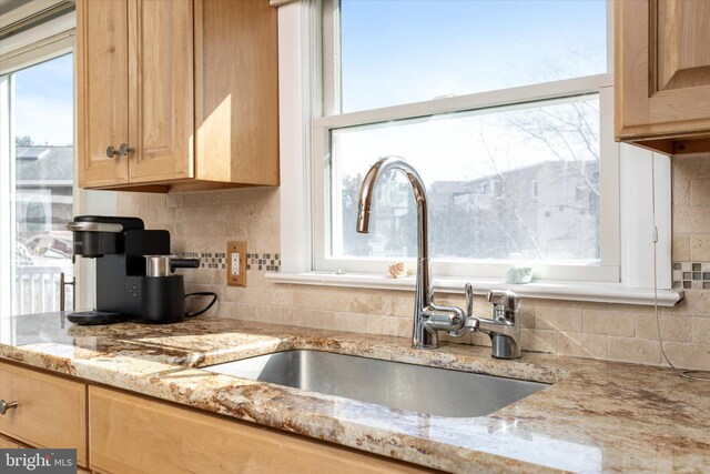 14 Buckingham Ave, Harvey Cedars, NJ 08008 - kitchen with a healthy amount of sunlight, a sink, and backsplash