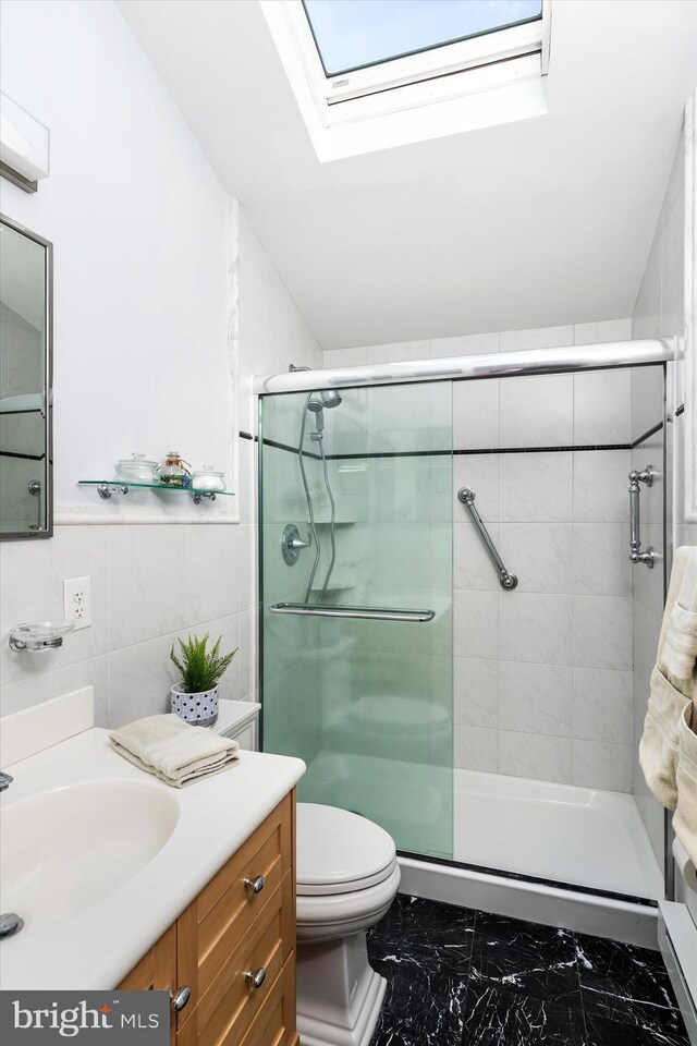 14 Buckingham Ave, Harvey Cedars, NJ 08008 - bathroom with a stall shower, a skylight, toilet, marble finish floor, and tile walls