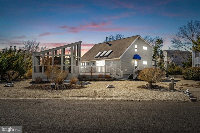14 Buckingham Ave, Harvey Cedars, NJ 08008 - view of front of property with a sunroom and a shingled roof