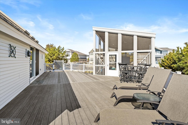 14 Buckingham Ave, Harvey Cedars, NJ 08008 - wooden deck with outdoor dining space and a sunroom