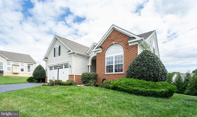 view of front of property featuring a garage, central AC, brick siding, driveway, and a front yard