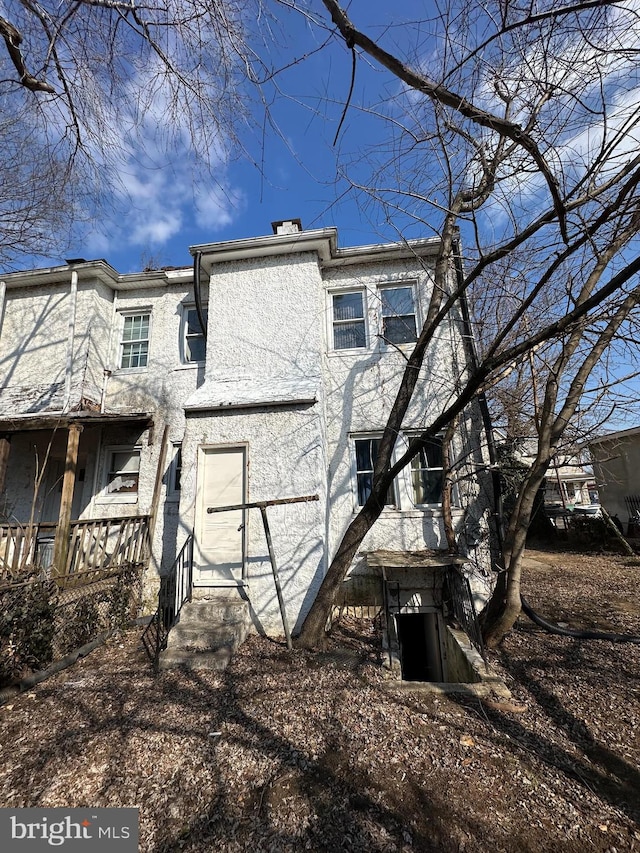 back of house featuring stucco siding