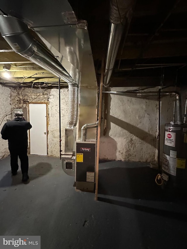 unfinished basement with gas water heater