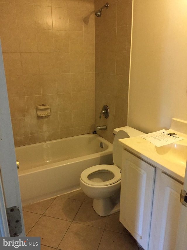 full bath featuring toilet, tile patterned flooring, washtub / shower combination, and vanity