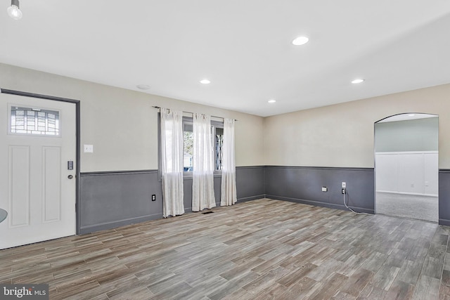 entrance foyer featuring a wainscoted wall, wood finished floors, and recessed lighting