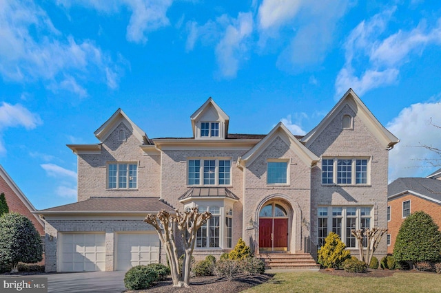 view of front of property with brick siding, an attached garage, and driveway