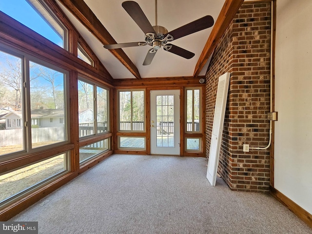 unfurnished sunroom with vaulted ceiling with beams and a ceiling fan