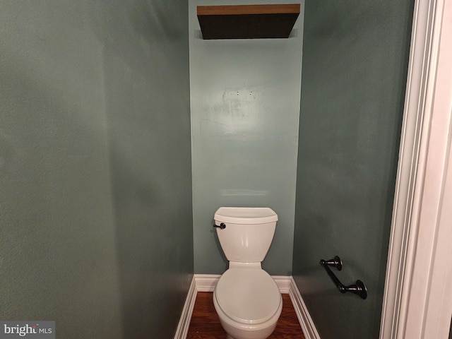 bathroom featuring wood finished floors, toilet, and baseboards