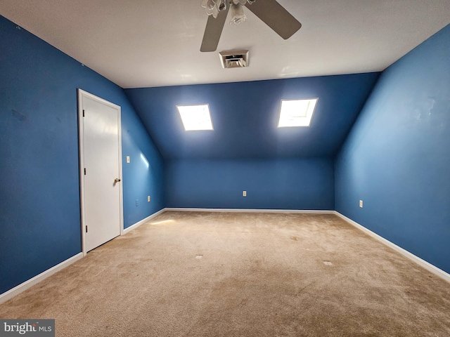 additional living space with carpet flooring, vaulted ceiling, visible vents, and baseboards