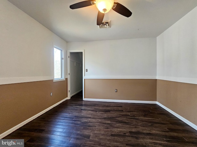 unfurnished room featuring a ceiling fan, baseboards, and dark wood-style flooring