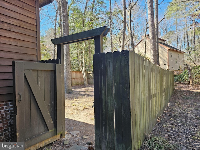 view of outdoor structure with fence and a gate