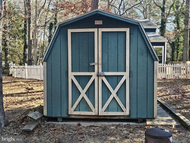 view of shed featuring fence