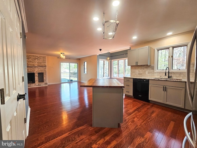 kitchen featuring a sink, black dishwasher, wooden counters, gray cabinets, and tasteful backsplash