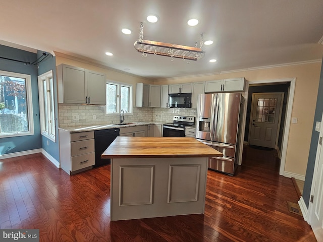 kitchen with gray cabinets, wooden counters, decorative backsplash, a sink, and black appliances