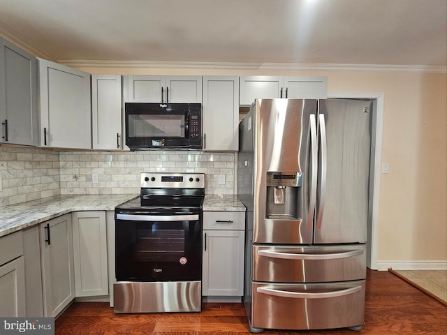 kitchen with appliances with stainless steel finishes, backsplash, dark wood finished floors, and crown molding