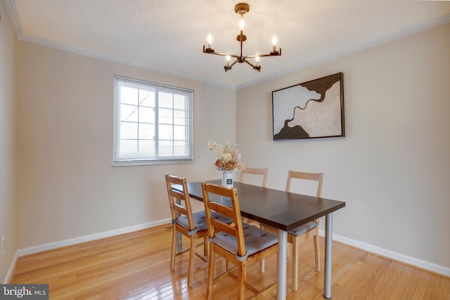 dining space featuring a notable chandelier, crown molding, baseboards, and hardwood / wood-style floors