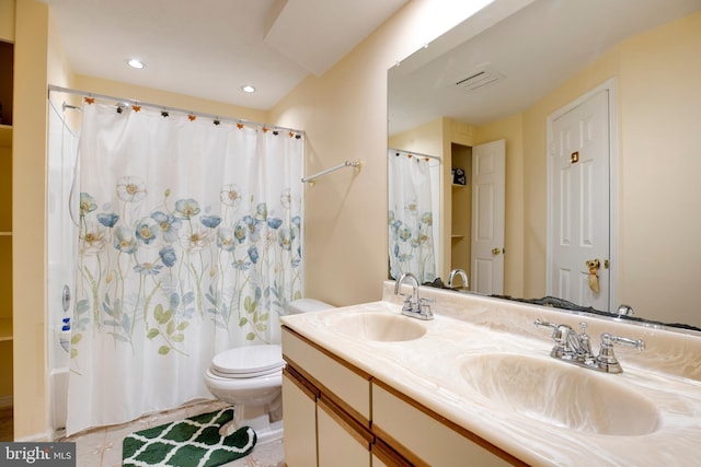 full bathroom with double vanity, a sink, toilet, and recessed lighting