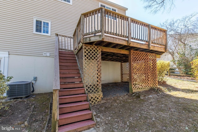 back of house featuring central AC unit, a wooden deck, and stairs