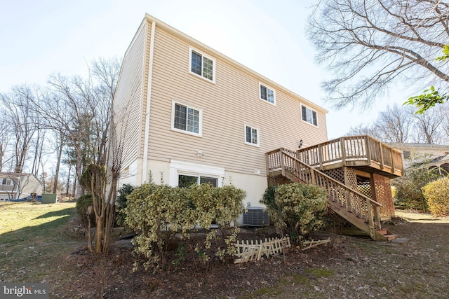 rear view of house with stairs, a deck, and central air condition unit