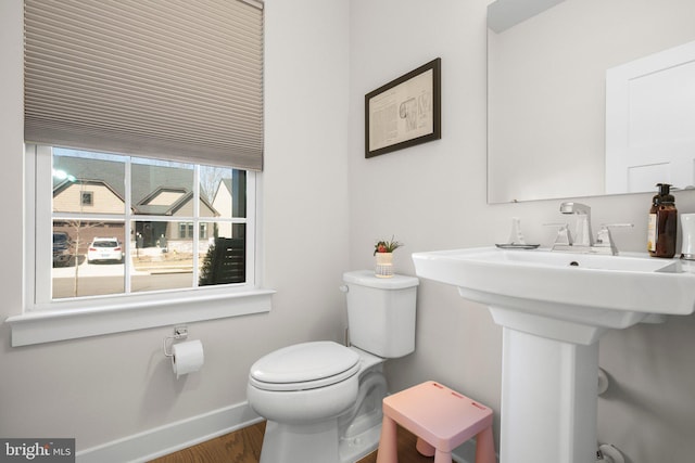 bathroom featuring wood finished floors, toilet, and baseboards