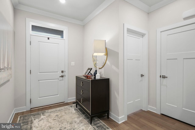 entrance foyer featuring crown molding, baseboards, and wood finished floors