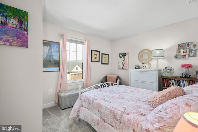 bedroom with light carpet, visible vents, and baseboards