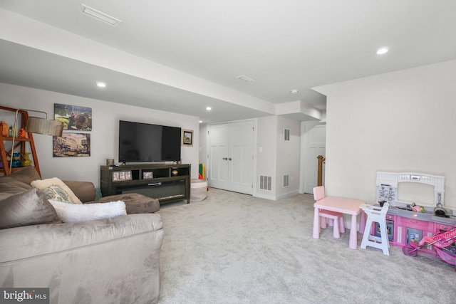 living room featuring light colored carpet, visible vents, and recessed lighting