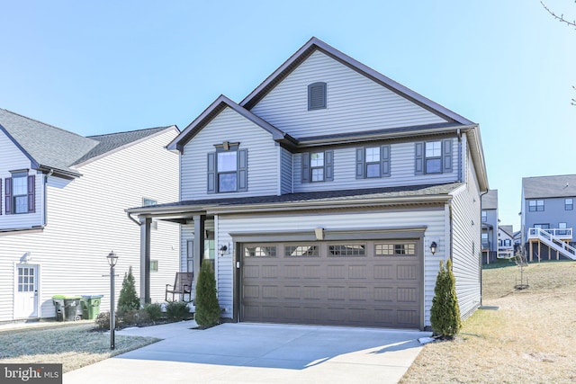 traditional-style house with a garage and concrete driveway