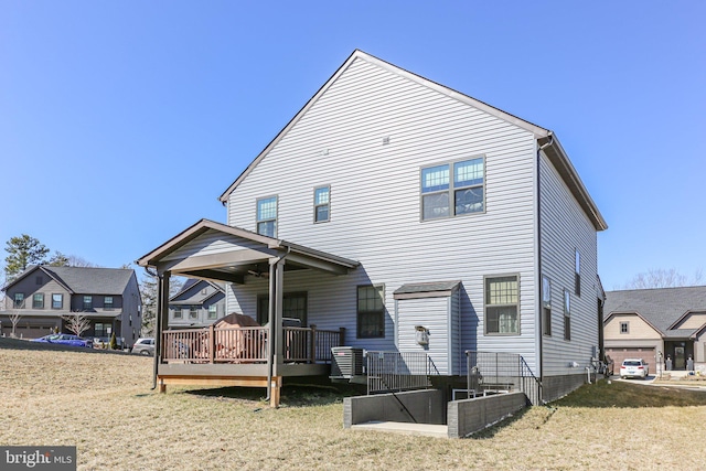 back of property with a lawn