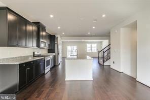 kitchen with stainless steel range with electric stovetop, open floor plan, dark wood finished floors, and a center island