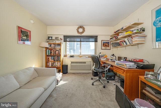 office area featuring an AC wall unit and light colored carpet