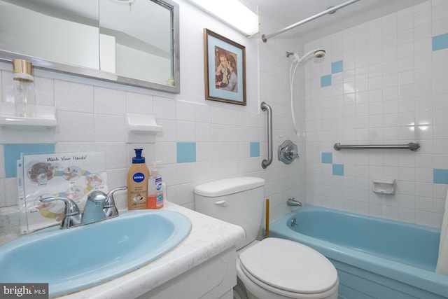 full bathroom featuring tile walls, vanity, toilet, and shower / bathtub combination